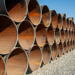 Line of oilfield large streel pipes in industrial construction area Line of oilfield large streel pipes in industrial construction area